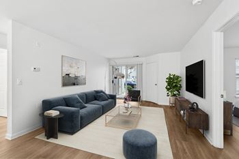 Living room with blue sofa and media console